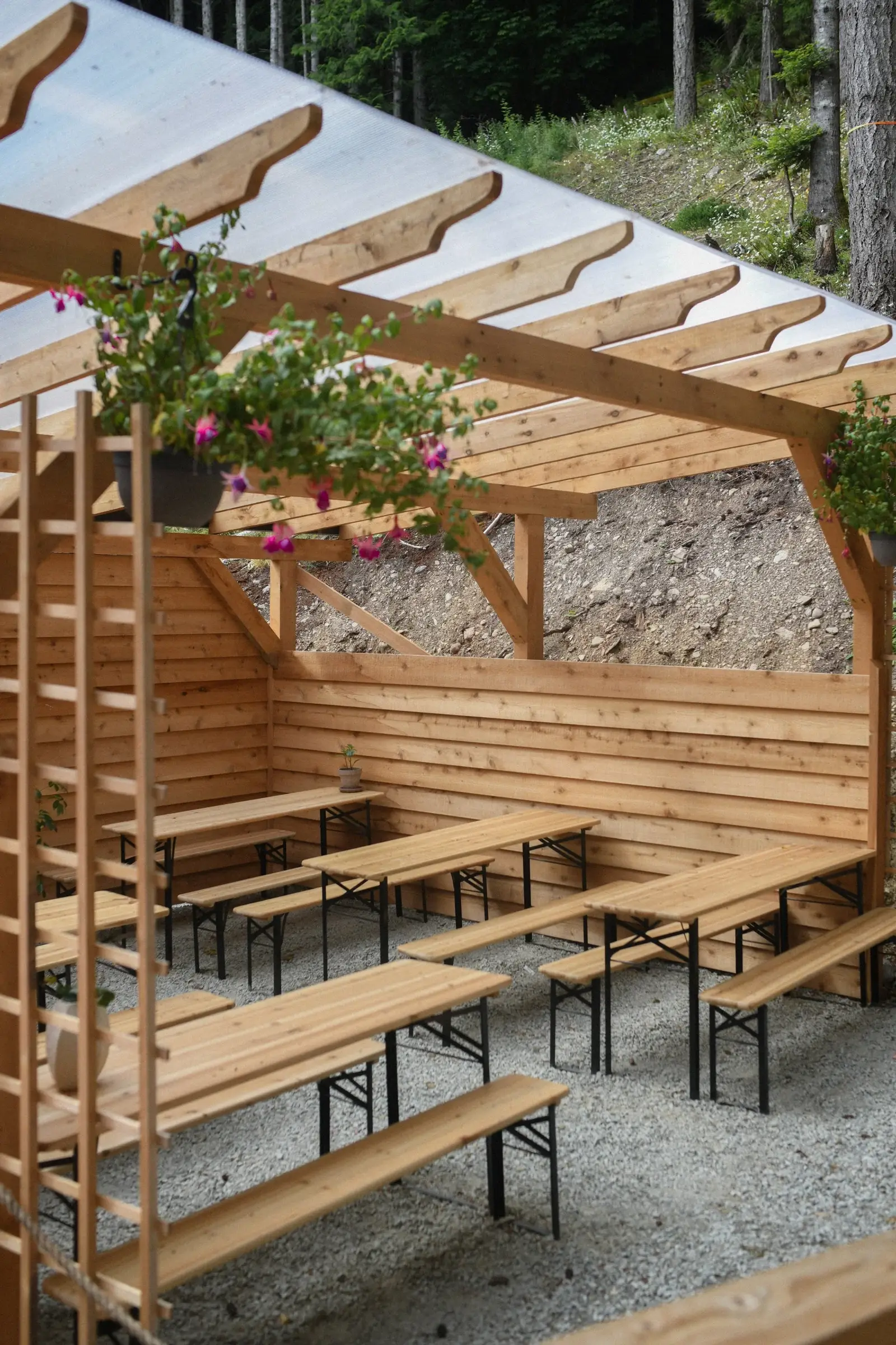The covered patio with wooden bench seating, ready to host a group